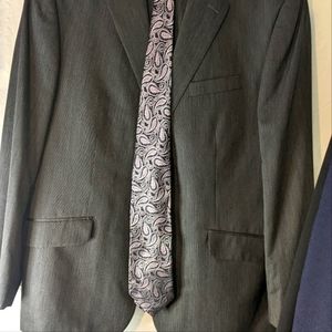 One charcoal grey mens Oxford Republic suit with platinum design tie